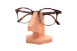 Soporte para gafas con forma de nariz visto en angulo sosteniendo unas gafas