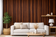 Vinilo decorativo efecto madera oscura cálida aplicado en pared detrás de un sofá
